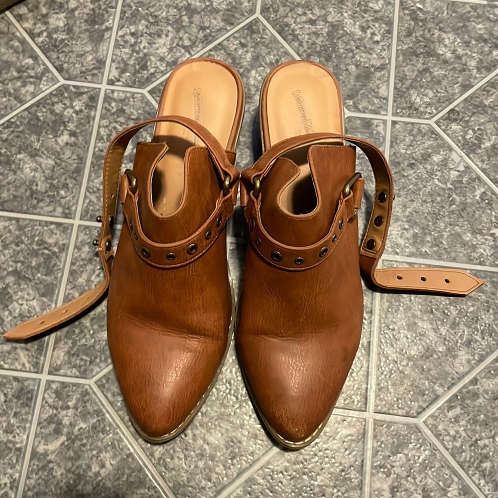 Brown/leather open heel boot with a rounded toe and strap detail
